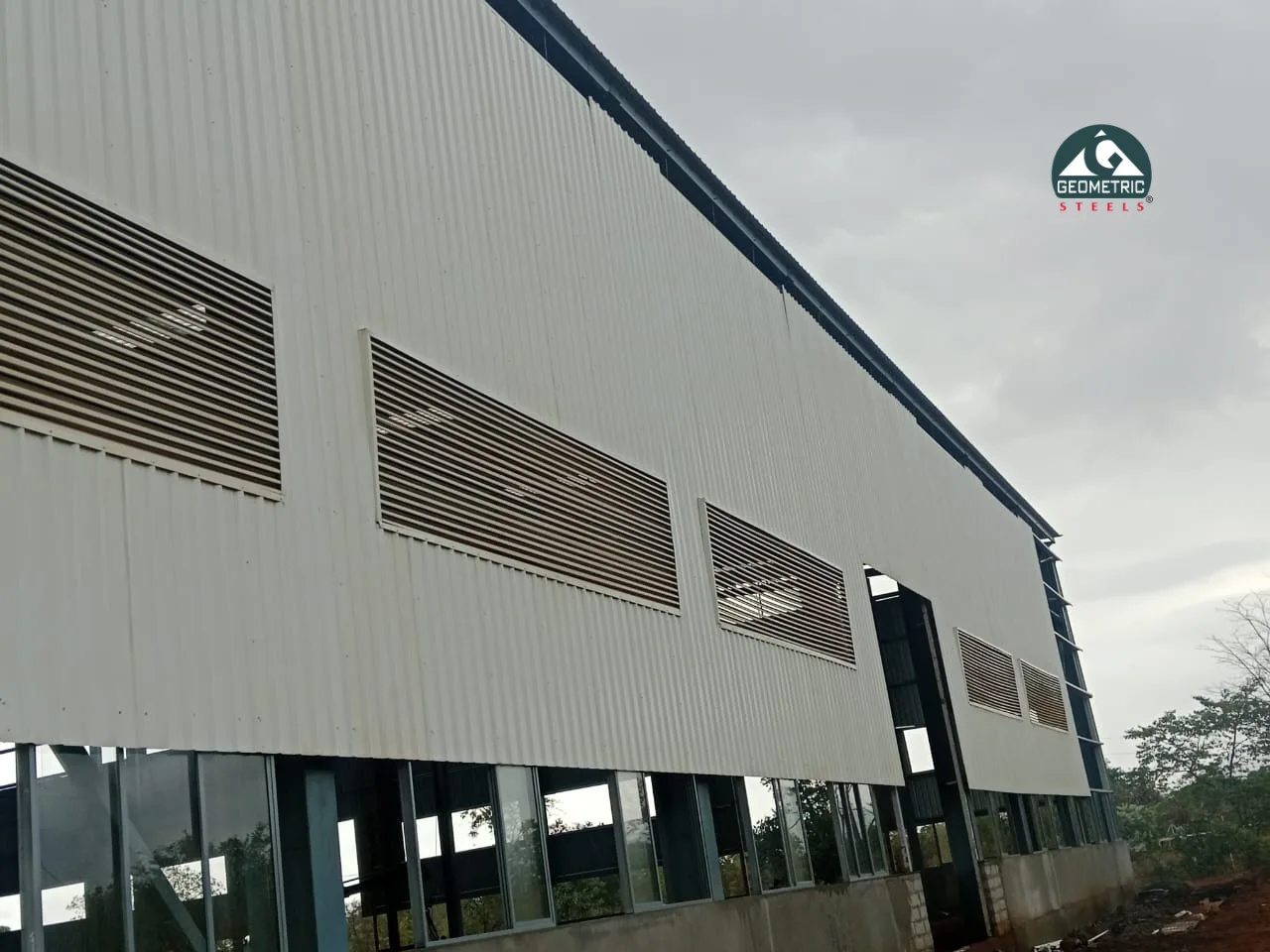 Geometric Steels industrial metal louvers providing fresh-air intake on a factory wall